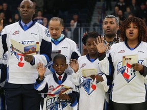 20 Newcomers to Canada take part in a citizenship ceremony on ice before a Blades hockey game during the "Welcome to the World" event at Sasktel Centre in Saskatoon on January 22, 2017.