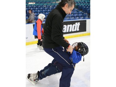 Saskatoon Blades President Steve Hogle skates with newcomers during the "Welcome the World" event at SaskTel Centre.