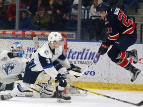 Saskatoon Blades' Jake Kustra tries blocking a shot while Regina Pats' Austin Wagner jumps to let it through during first period action against the at SaskTel Centre in Saskatoon on January 30, 2017.