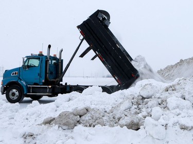 A truck empties snow in the newly opened Snow Management Facility on Valley Road in Saskatoon on January 9, 2017.