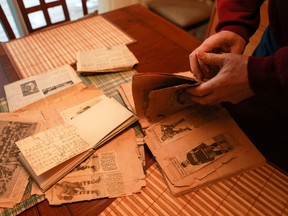 Al Mitchell flips through his father's old scrapbook and autograph book, which dates back to the early 1930s.
