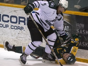 Jesse Forsberg of the University of Saskatchewan Huskies, left, takes out Riley Kieser of the University of Alberta Gold Bears during CIS hockey playoff action at Rutherford Areana in Saskatoon,  Friday, March 04, 2016.