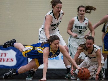 University of British Columbia Thunderbirds guard Krysten Lindquist and University of Saskatchewan Huskies guard Libby Epoch battle for a loose ball in first half CIS Women's basketball action at the PAC in Saskatoon, January 6, 2017.