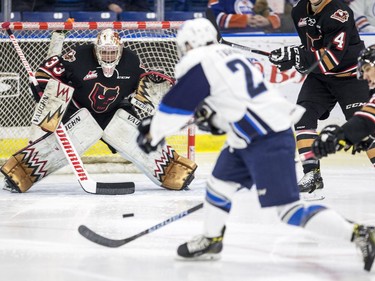 Calgary Hitmen goalie Kyle Dumba watches a shot come in from Saskatoon Blades forward Michael Farren during third period WHL action in Saskatoon, January 10, 2017.