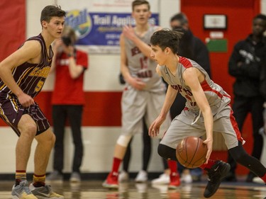 Bedford Road RedHawks guard Cody Clinkar moves the ball against Dr. Martin Leboldus Suns guard Todd Moyer during second quarter action of the opening game of the Bedford Road Invitational Tournament (BRIT) at Bedford Road Collegiate in Saskatoon, January 12, 2017.