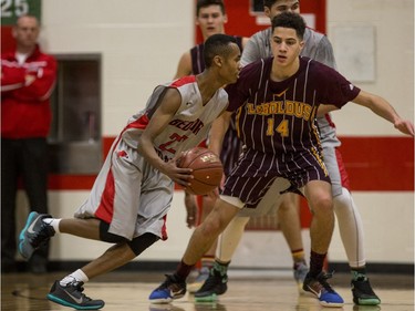 Bedford Road RedHawks guard Mohamed Salah moves the ball against  Dr. Martin Leboldus Suns forward Nick Barnard during first quarter action of the opening game of the Bedford Road Invitational Tournament (BRIT) at Bedford Road Collegiate in Saskatoon, January 12, 2017.