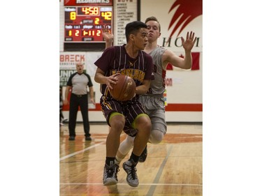 Dr. Martin Leboldus Suns guard Ivan Santos sets up a play as Bedford Road RedHawks guard Quinten Reichel defends during second quarter action of the opening game of the Bedford Road Invitational Tournament (BRIT) at Bedford Road Collegiate in Saskatoon, January 12, 2017.