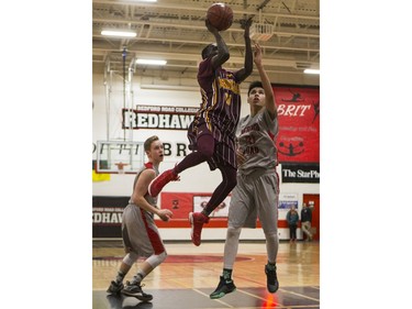 Dr. Martin Leboldus Suns guard Moses Onion gets a shot past Bedford Road RedHawks forward Kennan Umpherville during second quarter action of the opening game of the Bedford Road Invitational Tournament (BRIT) at Bedford Road Collegiate in Saskatoon, January 12, 2017.