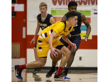 Dr. Martin Leboldus Suns forward Matt Barnard moves the ball against the St. Francis Xavier Rams during their game in the Bedford Road Invitational Tournament (BRIT) at Bedford Road Collegiate in Saskatoon, January 13, 2017.