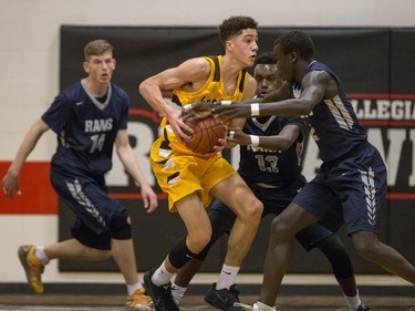 Dr. Martin Leboldus Suns forward Matt Barnard attempts to keep the ball away from the St. Francis Xavier Rams during their game in the Bedford Road Invitational Tournament (BRIT) at Bedford Road Collegiate in Saskatoon, January 13, 2017.