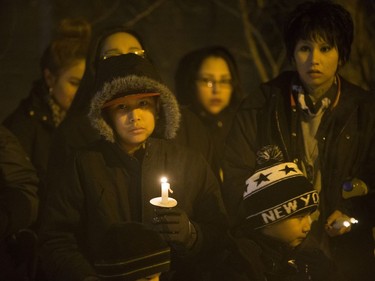 A group stands outside the entrance of SHARP to hold a vigil for Rudy Kishayinew, whose body was found outside St. Paul's hospital on January 1 in Saskatoon, January 13, 2017.