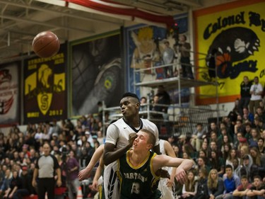 Campbell Collegiate Tartans guard Jesse Trussler gets knocked down by a St. Francis Xavier Rams player during the final game of the Bedford Road Invitational Tournament in Saskatoon, January 14, 2017.