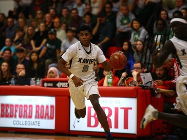 St. Francis Xavier Rams guard Geoffery James runs the ball down the court during play against the Campbell Collegiate Tartans at the final game of the Bedford Road Invitational Tournament in Saskatoon, January 14, 2017.