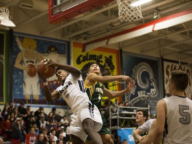 St. Francis Xavier Rams guard Geoffery James attempt to make a basket against the Campbell Collegiate Tartans during the final game of the Bedford Road Invitational Tournament in Saskatoon, January 14, 2017.