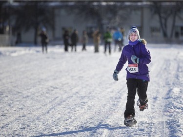 Jillian Kulbida runs to the finish line during the 4x1 fun race at the Special Olympics Snow Shoe Tournament at E.D. Feehan High School in Saskatoon, January 14, 2017.