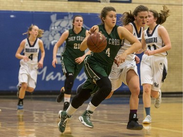 Holy Cross Crusaders' Samantha Revering moves the ball against the Walter Murray Marauders  in high school girl's basketball action at Walter Murray Collegiate in Saskatoon, January 17, 2017.