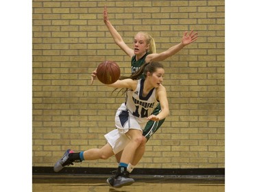 Walter Murray Marauders' Emma Engen moves the ball past Holy Cross Crusaders' Emma Linsley  in high school girl's basketball action at Walter Murray Collegiate in Saskatoon, January 17, 2017.