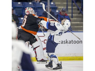 Medicine Hat Tigers goalie Michael Bullion hits Saskatoon Blades forward Caleb Fantillo during first period WHL action in Saskatoon, January 18, 2017. Bullion got a two minute roughing penalty and the Blades scored on the power play.