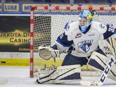 Saskatoon Blades goalie Logan Flodell watches a shot from the Medicine Hat Tigers during first period WHL action in Saskatoon, January 18, 2017.