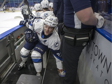 Saskatoon Blades forward Braylon Shmyr jokes with training staff on the bench after scoring a goal against the Medicine Hat Tigers during first period WHL action in Saskatoon, January 18, 2017.
