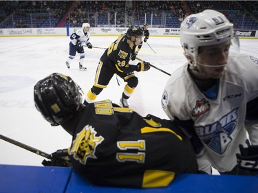 Brandon Wheat Kings forward #28 Baron Thompson skates down the ice past two players colliding at SaskTel Centre in Saskatoon, January 20, 2017.