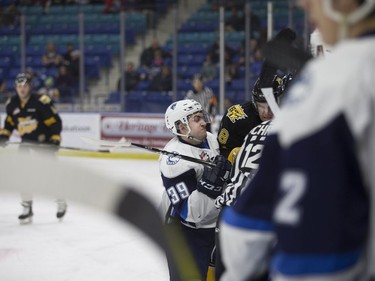 Saskatoon Blades forward Caleb Fantillo checks a Brandon Wheat Kings player into the boards at SaskTel Centre in Saskatoon, January 20, 2017.