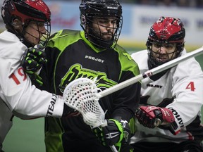 Vancouver Stealth's Justin Salt, left, attacks Saskatchewan Rush forward Adam Jones, alongside Stealth defence Chris O'Dougherty, right, at the SaskTel Centre in Saskatoon, Sask. on Friday, Jan. 27, 2017.