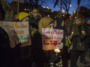 People gather for a solidarity vigil for the victims on the attack on the mosque in Quebec City and to protest President Donald Trump's travel ban at Saskatoon city hall in Saskatoon, January 31, 2017.