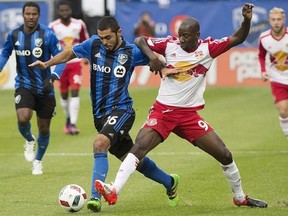 Montreal Impact&#039;s Victor Cabrera, left, challenges New York Red Bulls&#039; Bradley Wright-Phillips during first half action of the first leg of the Eastern Conference MLS soccer semifinal in Montreal, Sunday, October 30, 2016. When English striker Wright-Phillips arrived in Major League Soccer, he was looking forward to seeing North America.Then the reality of MLS travel set in for the New York Red Bulls star. THE CANADIAN PRESS/Graham Hughes
