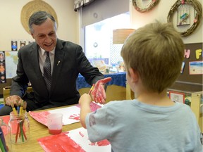 Saskatchewan Education Minister Don Morgan participates in a Canada Day art project with five-year-old Boston Hickey at the Awasis Child Care Co-op at the U of Regina on June 17, 2014.