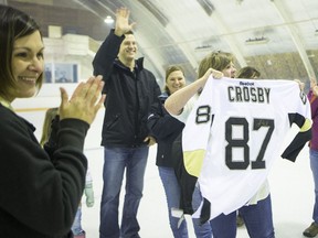 Cst. Ryan Ehalt (Left) donates a signed Sydney Crosby jersey to the Community Rink in Asquith, Sask. on Friday, February 17, 2017.