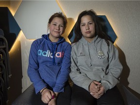 Adele Roberts, age 13, left, and Codie Charles, age 13, both from Stanley Mission, sit for a photograph during the Ignite the Life Rally at the Saskatoon Inn on Feb. 2, 2017