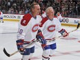 Guy Lafleur skates with Doug Jarvis during warm up before the NHL game against the Boston Bruins on December 4, 2009 at the Bell Center in Montreal, Quebec, Canada.