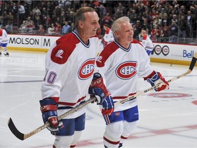 Guy Lafleur skates with Doug Jarvis during warm up before the NHL game against the Boston Bruins on December 4, 2009 at the Bell Center in Montreal, Quebec, Canada.