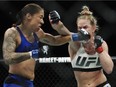 Germaine de Randamie, left, of the Netherlands, punches Holly Holm during a women's featherweight championship mixed martial arts bout at UFC 208 early Sunday, Feb. 12, 2017, in New York. De Randamie won the fight.