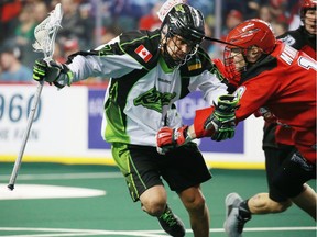 Saskatchewan's Jeremy Thompson tangles with the Calgary Roughnecks' Curtis Manning during NLL action Saturday.