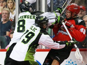 Saskatchewan's Nik Bilic and Mike Messenger get tough with Calgary's Jon Harnett during recent NLL action.