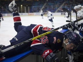 Regina Pats defender Liam Schioler gets checked into the boards during the game against the Saskatoon Blades at the SaskTel Centre in Saskatoon on February 3, 2017. (Saskatoon StarPhoenix/Kayle Neis)