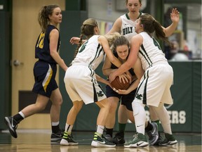 Evan Hardy Souls' Megan Dumba attempts to keep the ball away from the Holy Cross Crusaders during high school girls basketball action at Holy Cross High School in Saskatoon, February 7, 2017.