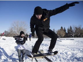 Jensen Fisker from Burlington, Ontario films Josh Oakes who skates for Ambition snowskates at Lions Skatepark in Saskatoon, Sask. on Saturday, Feb. 11, 2017.