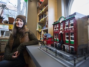 Sandie Irvine sits beside her lego model of the now demolished Lydia's Pub at Turning The Tide Bookstore in Saskatoon, SK on Tuesday, February 21, 2017. (Saskatoon StarPhoenix/Kayle Neis)