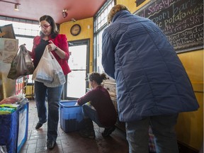Nicole White (left) unloads bags of donated menstrual products for women in need at D'Lish Cafe in Saskatoon, SK on Friday, February 24, 2017.