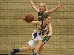 Walter Murray Marauders Emma Engen moves the ball past Holy Cross Crusader Emma Linsley in High School Girl's Basketball action at Walter Murray Collegiate in Saskatoon, SK on Tuesday, January 17, 2017.