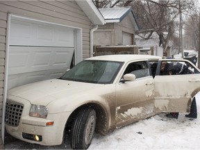 Saskatoon Police respond after to a car that crashed in to a garage after pursuing a car with 4 occupants and a shotgun in the alley of the 100 block of 32nd Street in Saskatoon, SK. on Saturday, March 21, 2015.