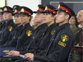 Brandon Roberts, right, is sworn in as a Special Constable with the Saskatoon Police Service during a ceremony at the police station, Monday, January 05, 2015.