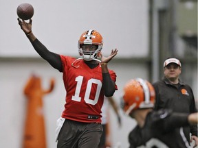 In this April 29, 2014, file photo, then-Cleveland Browns quarterback Vince Young throws during a voluntary minicamp workout at the team's NFL football training facility in Berea, Ohio. The agent representing former NFL quarterback Vince Young says he's talking to the Saskatchewan Roughriders about his client playing in the CFL.