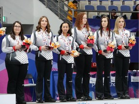 GANGNEUNG, SOUTH KOREA - FEBRUARY 26:  (L to R) Coach Amanda Dawn St. Laurent and bronze medalists Karlee Burgess, Brenna Bilassy, Kate Goodhelpsen, Chantele Broderson and Kristen Streifel of Canada celebrate in the medal ceremony for Women's during the VolP Defender World Junior Curling Championships 2017 at Gangneung Curling Centre on February 26, 2017 in Gangneung, South Korea.