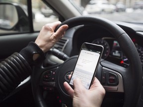 A driver texts while at the wheel.