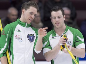 Saskatchewan skip Adam Casey, left, and third Catlin Schneider discuss a shot as the play New Brunswick in draw 9 action at the Tim Hortons Brier curling championship at Mile One Centre in St. John's on Tuesday, March 7, 2017. Saskatchewan won 7-6.