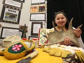Grade 6 student Emily Benjoe holds a moose antler at her display on the moose and its various uses, from clothing to weapons and accessories, during the First Nations Science Fair at Prairieland Park in Saskatoon on March 19, 2017.
